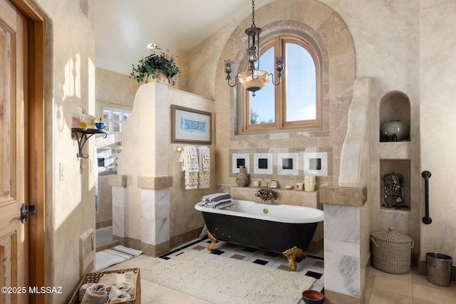 full bathroom with a walk in shower, a freestanding tub, tile patterned flooring, and tile walls