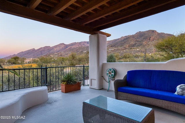 view of patio / terrace featuring a balcony, a mountain view, and an outdoor hangout area