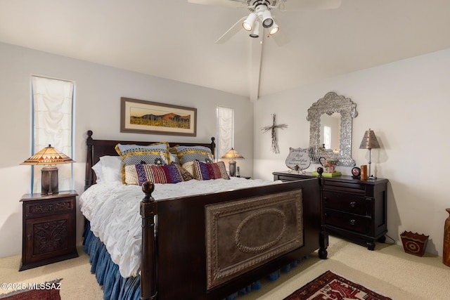 bedroom featuring lofted ceiling, light carpet, and multiple windows