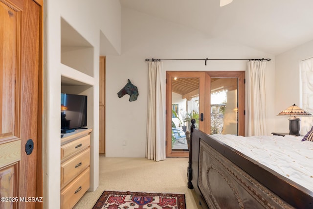 bedroom with lofted ceiling, access to exterior, and light colored carpet