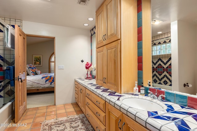 full bathroom with tile patterned flooring, connected bathroom, visible vents, vanity, and walk in shower