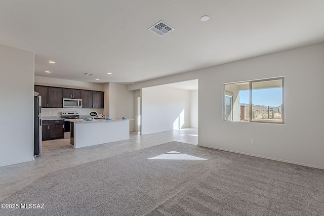 unfurnished living room featuring light carpet