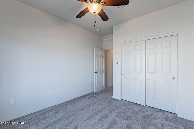 unfurnished bedroom with ceiling fan, a closet, and carpet