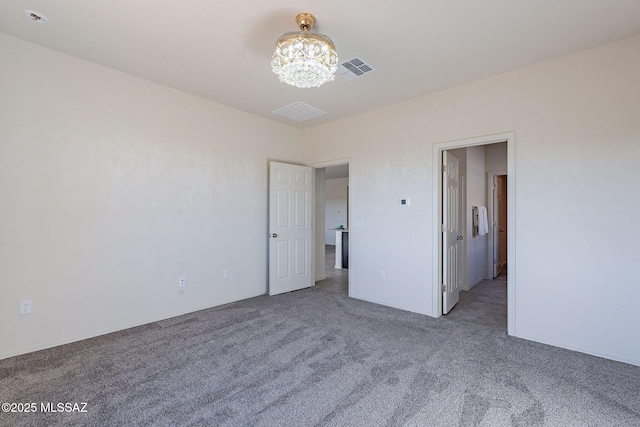 unfurnished bedroom featuring carpet floors and a notable chandelier