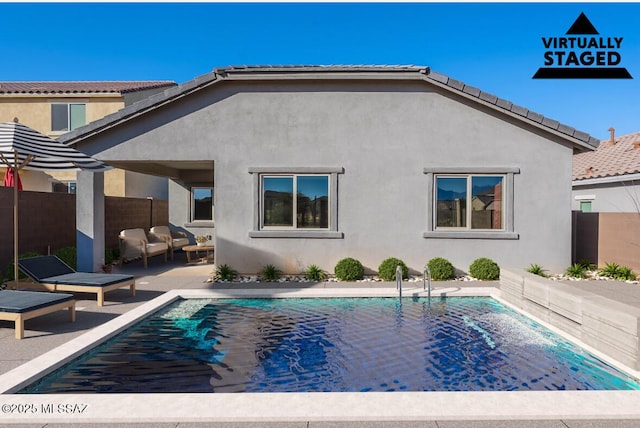 back of house featuring an outdoor living space and a patio