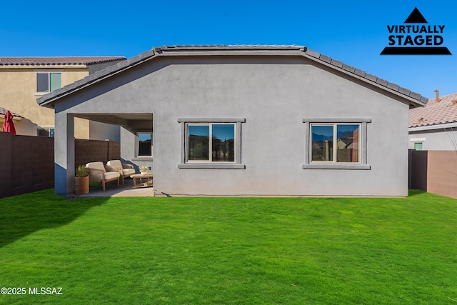 back of property with a patio, an outdoor hangout area, and a lawn