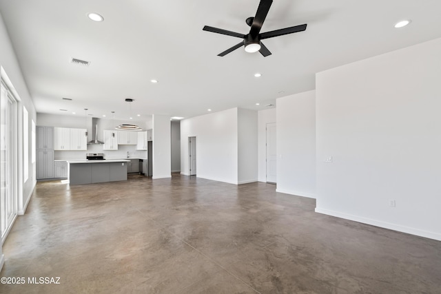 unfurnished living room featuring concrete flooring and ceiling fan