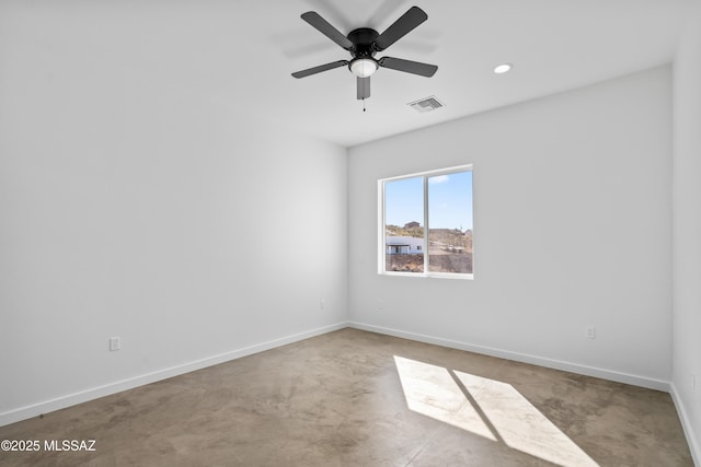 spare room featuring concrete flooring and ceiling fan