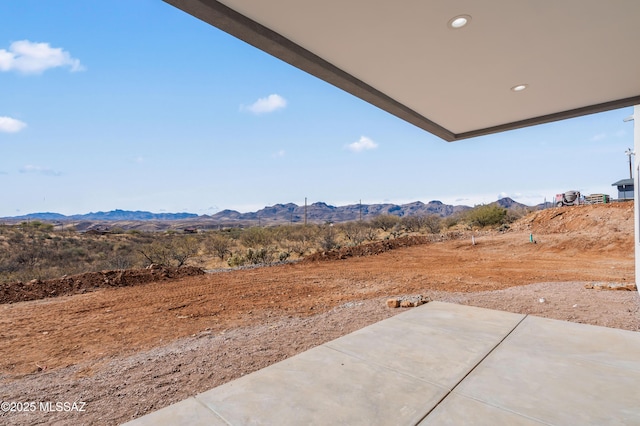 view of yard featuring a mountain view and a patio area