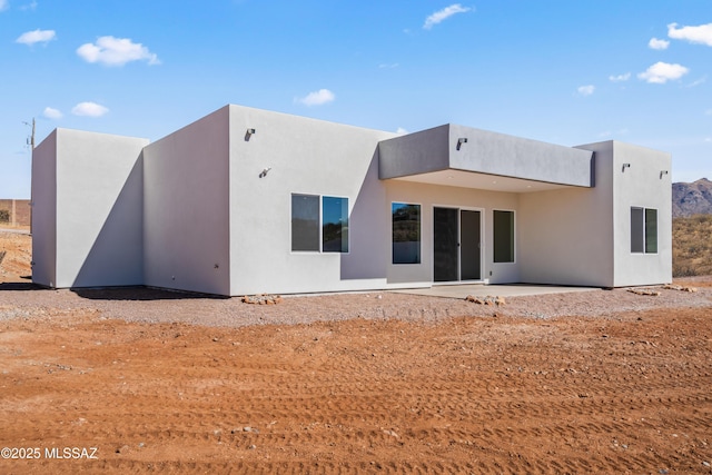 rear view of property featuring a patio area