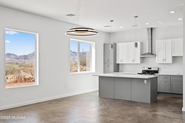 kitchen with pendant lighting, gray cabinetry, stainless steel range with electric stovetop, a mountain view, and wall chimney exhaust hood