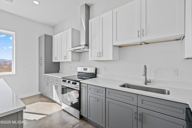 kitchen with sink, gray cabinetry, electric range, light stone countertops, and wall chimney exhaust hood