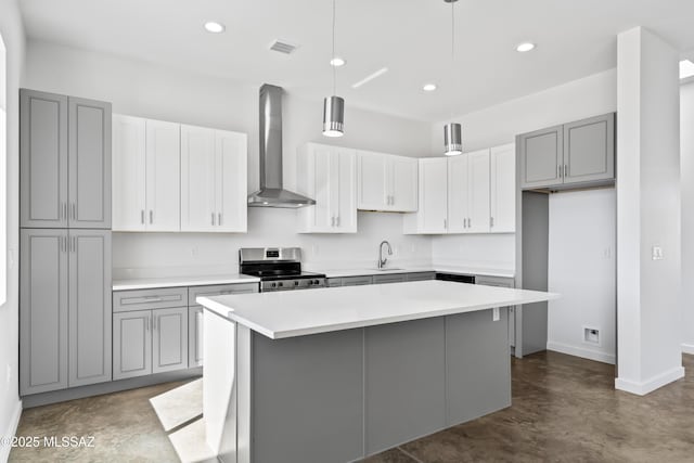 kitchen with a center island, wall chimney range hood, hanging light fixtures, and stainless steel electric range oven