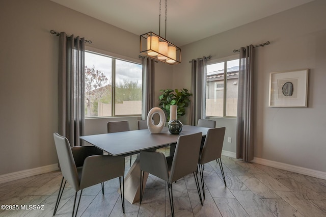 dining room with baseboards and marble finish floor