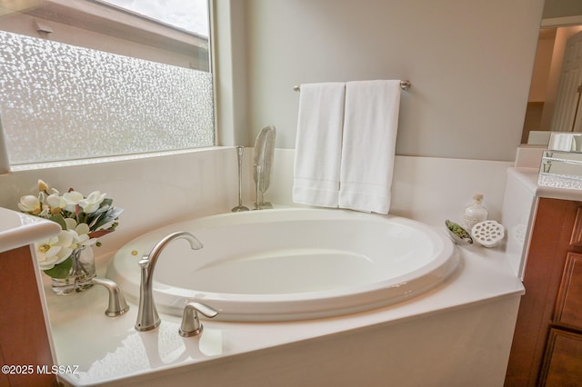 bathroom with a bath and vanity