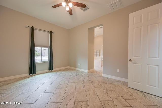 unfurnished room featuring ceiling fan, baseboards, and visible vents