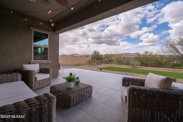 view of patio with an outdoor living space and a fenced backyard