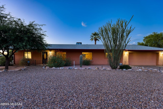 ranch-style home featuring a garage