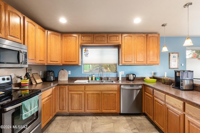 kitchen with stainless steel appliances, decorative light fixtures, and sink