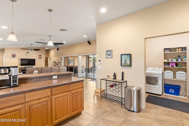 kitchen featuring hanging light fixtures, washer / dryer, light tile patterned floors, and ceiling fan