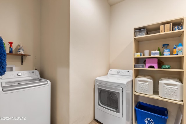 clothes washing area with washing machine and dryer