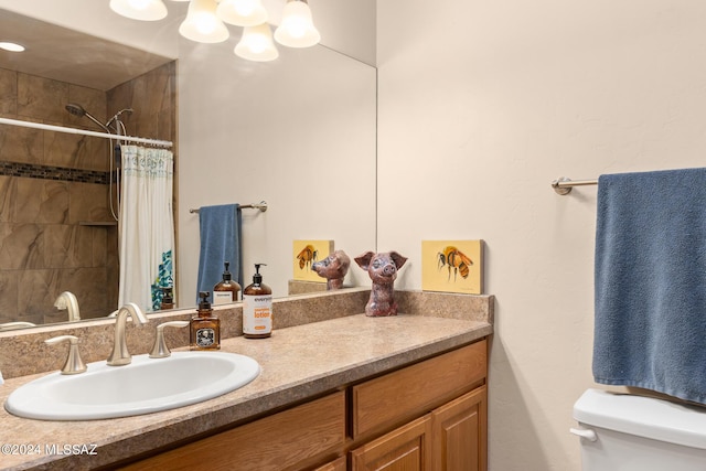 bathroom with walk in shower, vanity, and toilet