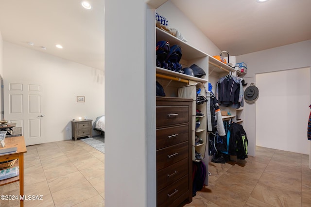 walk in closet featuring light tile patterned flooring