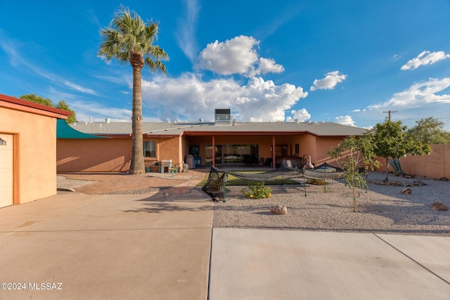 view of front of house with central AC and a patio