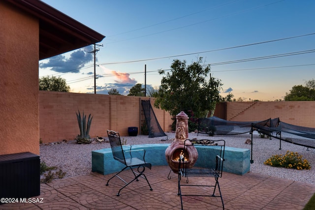 view of patio terrace at dusk