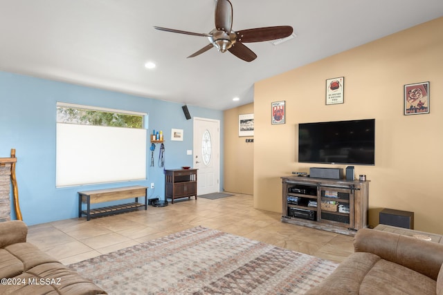 living room featuring ceiling fan and vaulted ceiling