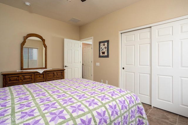 tiled bedroom with a closet and ceiling fan