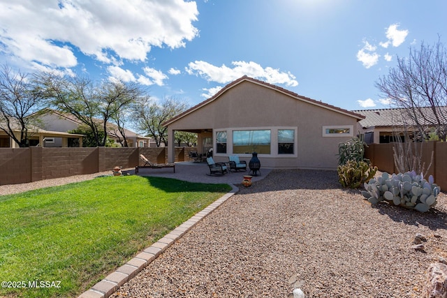 rear view of property with a patio area and a lawn