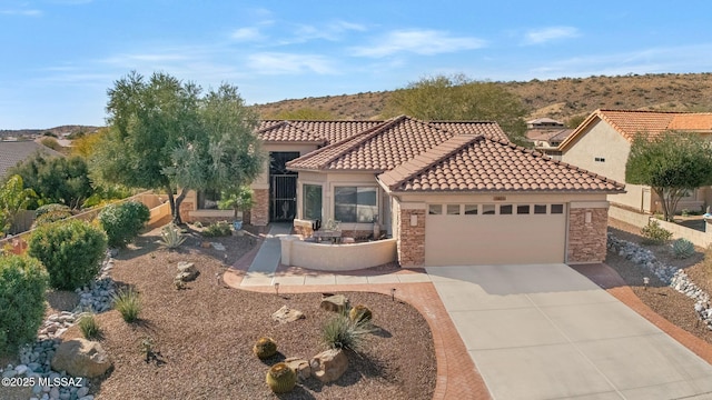 mediterranean / spanish-style home with a garage