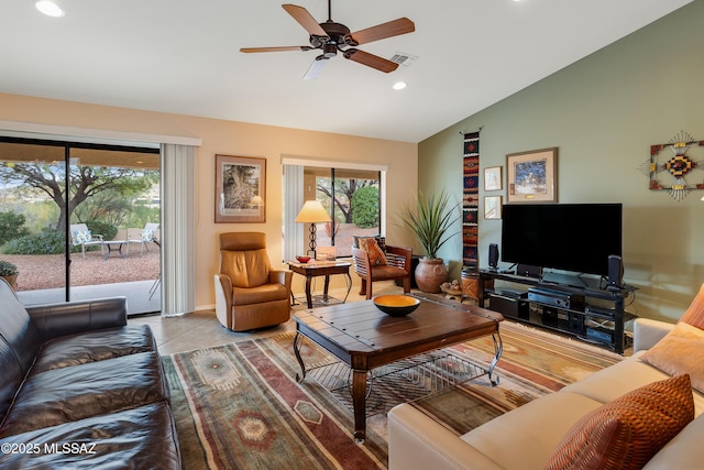 living room with plenty of natural light, tile patterned floors, lofted ceiling, and ceiling fan