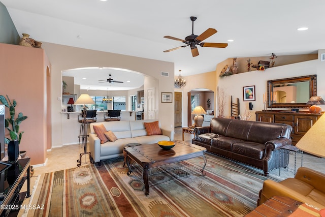 living room with ceiling fan with notable chandelier and carpet floors