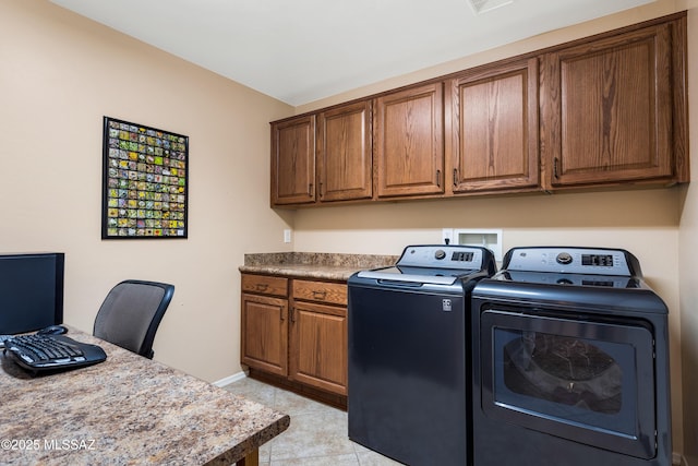 washroom with cabinets, light tile patterned floors, and independent washer and dryer