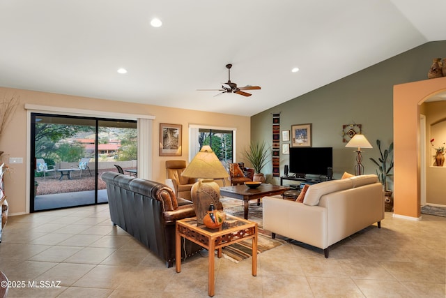 living room featuring lofted ceiling, light tile patterned floors, and ceiling fan