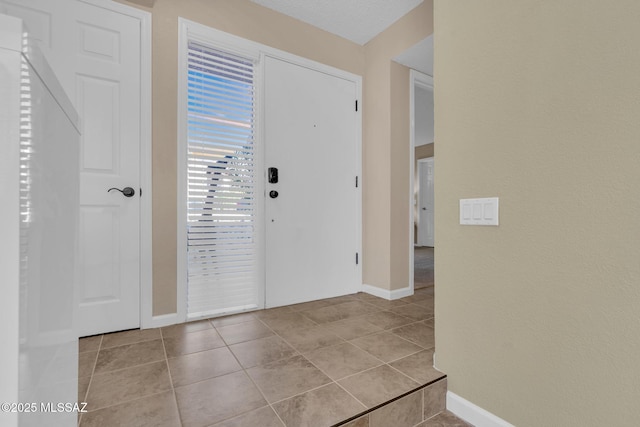 foyer entrance with light tile patterned flooring