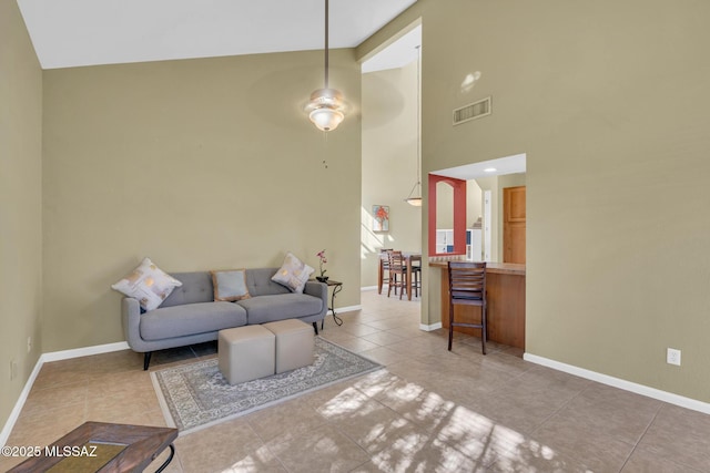 tiled living room featuring high vaulted ceiling and ceiling fan