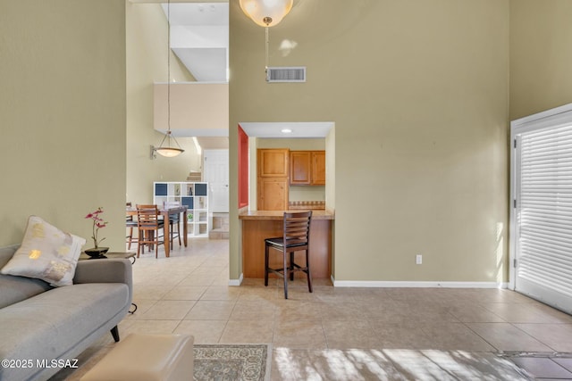 tiled living room with a high ceiling