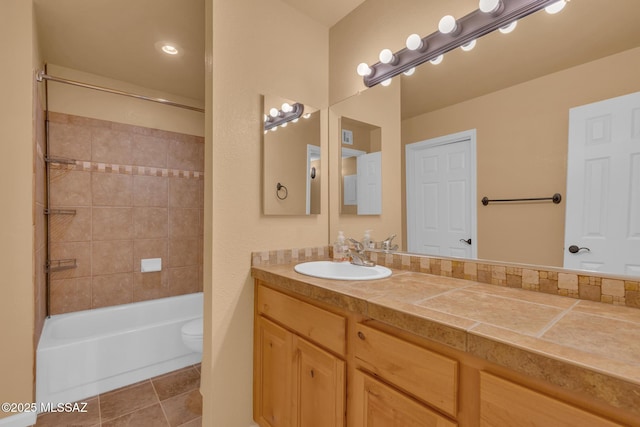 full bathroom featuring tile patterned flooring, vanity, toilet, and tiled shower / bath