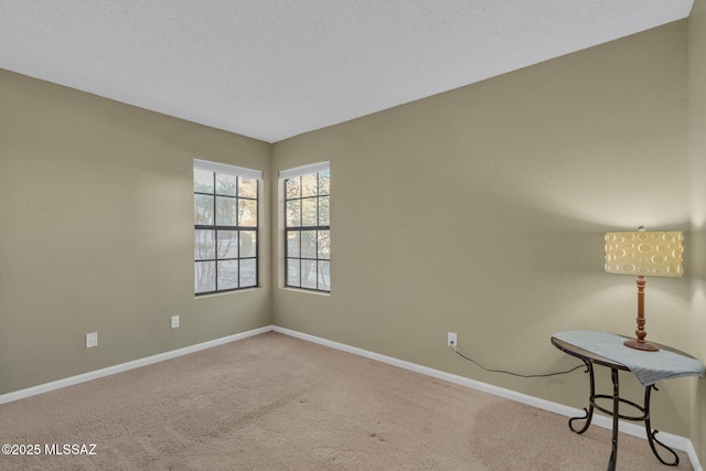 carpeted empty room with a textured ceiling