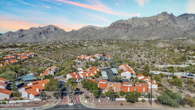 aerial view at dusk featuring a mountain view