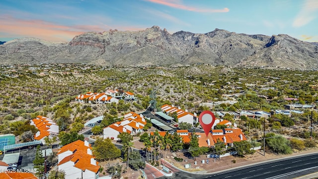 aerial view at dusk featuring a mountain view