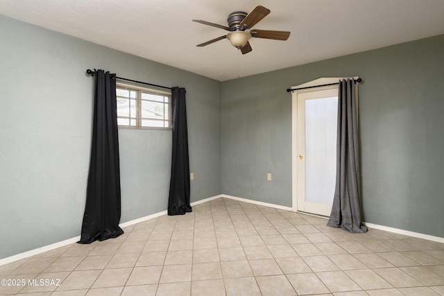 empty room featuring ceiling fan and light tile patterned floors