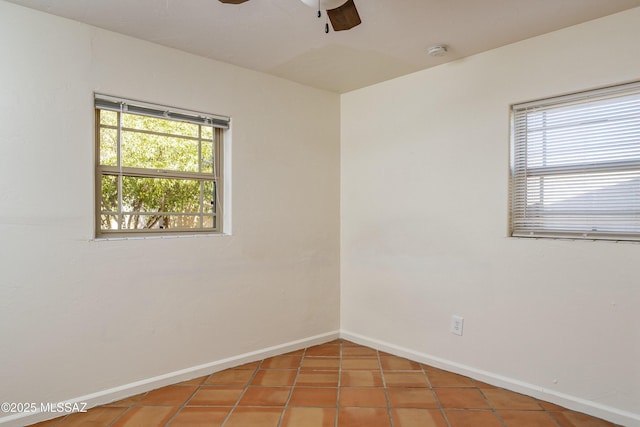 empty room with tile patterned floors and ceiling fan