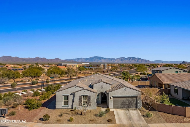 view of front facade with a garage and a mountain view