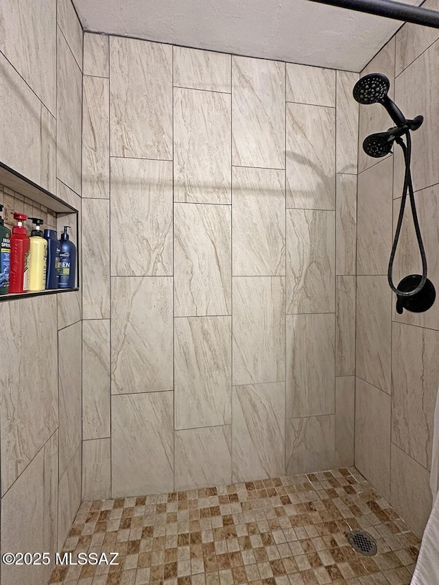 bathroom with a tile shower