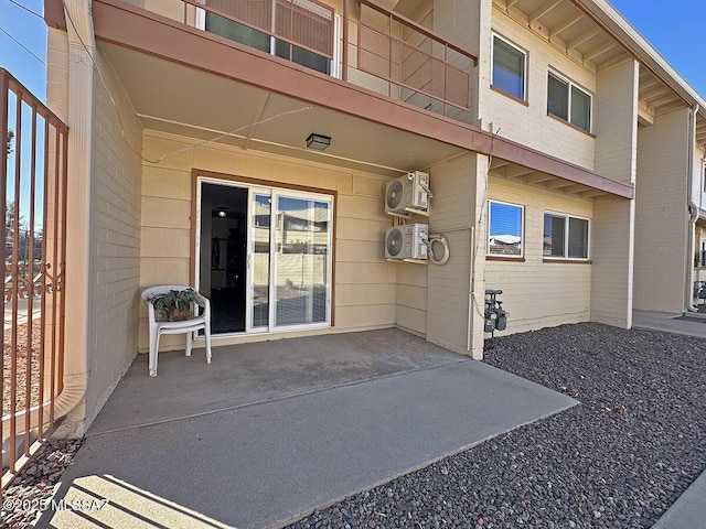 property entrance featuring ac unit and a patio