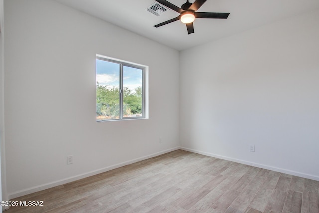 spare room featuring ceiling fan and light hardwood / wood-style flooring